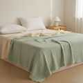 Six-layer cotton gauze blanket draped over a bed